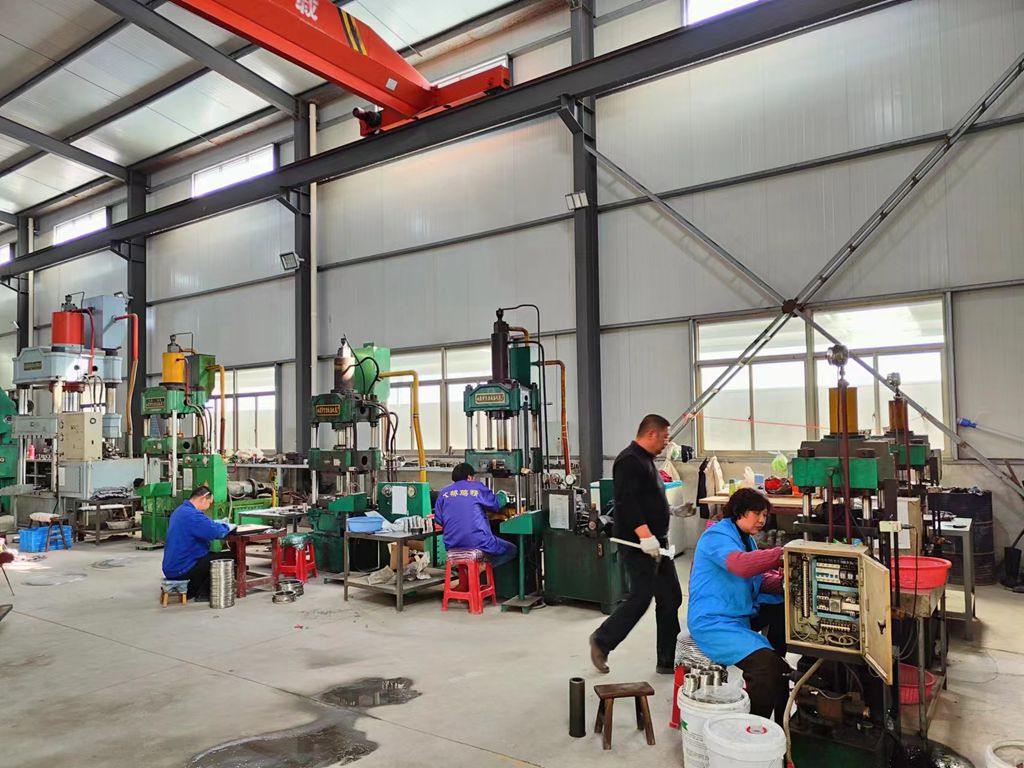 Disc spring production workshop with forming equipment and operators